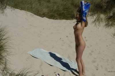 Красотка без трусиков на пляже под солнцем