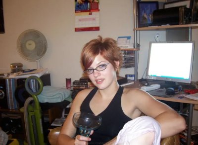 Грудастая красотка с огненными волосами демонстрирует свое обольстительное тело и возбуждающие интимные места