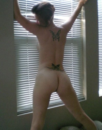 Развратная дама с татуировкой бабочки на спине демонстрирует свое обнаженное тело на частных снимках