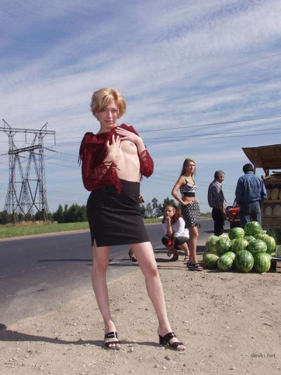 Очаровательная девушка раздевается на улице для откровенной фотосессии