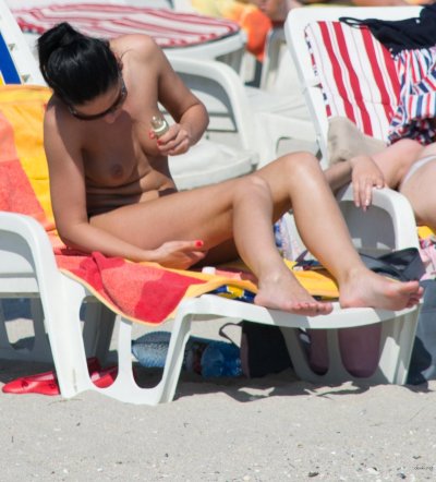 Обнаженные дамы отдыхают на берегу